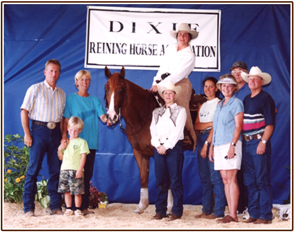 The winners circle at the Dixie Reining Horse Show in 2002, with Junior, his rider, and their supporters.