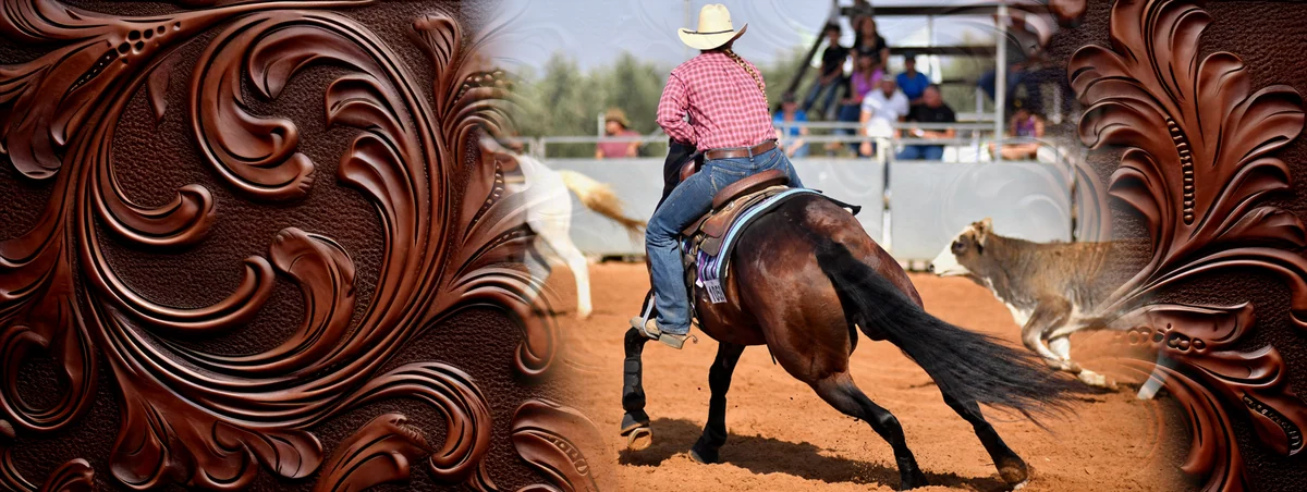 A western rider on a dark horse working a cow in an arena.